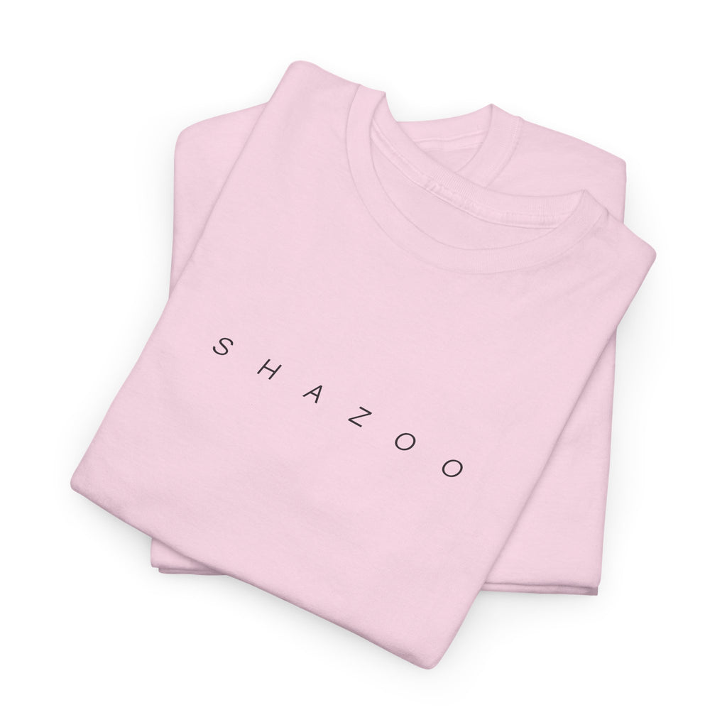 Folded pink t-shirt with 'SHAZOO' text on a white background