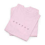 Folded pink t-shirt with 'SHAZOO' text on a white background